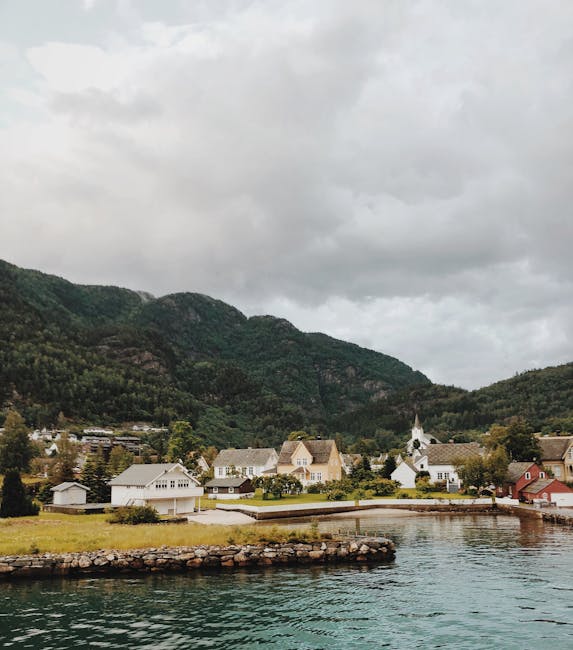 Serene landscape with small houses by the water